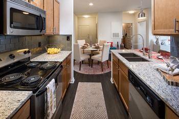 view of kitchen and dining room with granite counter tops